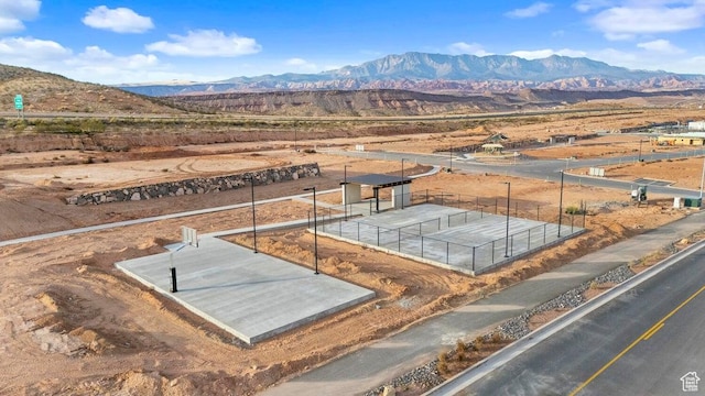 birds eye view of property featuring a mountain view and a desert view