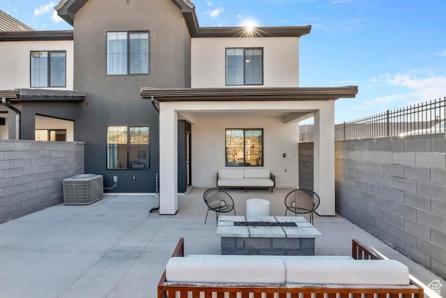 back of property featuring stucco siding, a patio, a fenced backyard, cooling unit, and outdoor lounge area