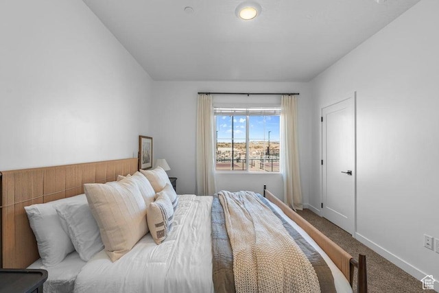 carpeted bedroom featuring baseboards