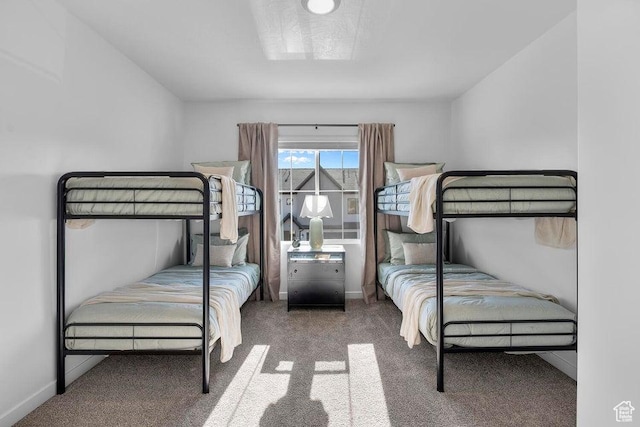 bedroom with baseboards and carpet