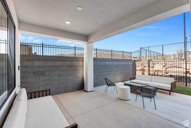 view of patio featuring an outdoor living space and fence