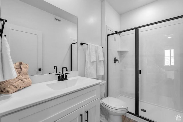 full bathroom featuring vanity, toilet, and a stall shower
