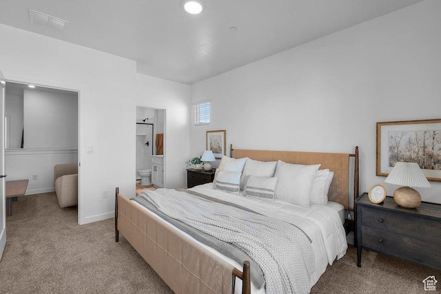 bedroom featuring visible vents, light carpet, baseboards, and connected bathroom