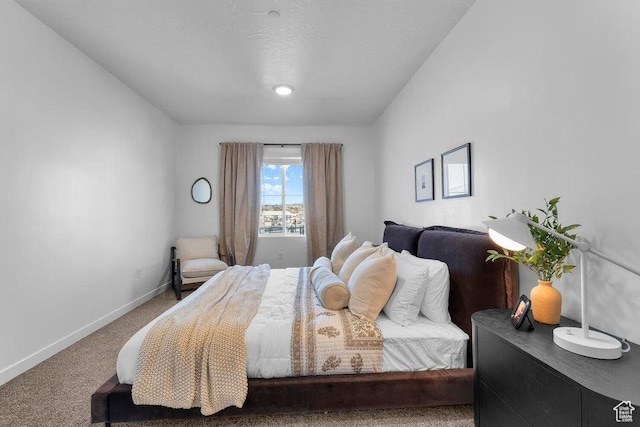 bedroom featuring baseboards and carpet flooring