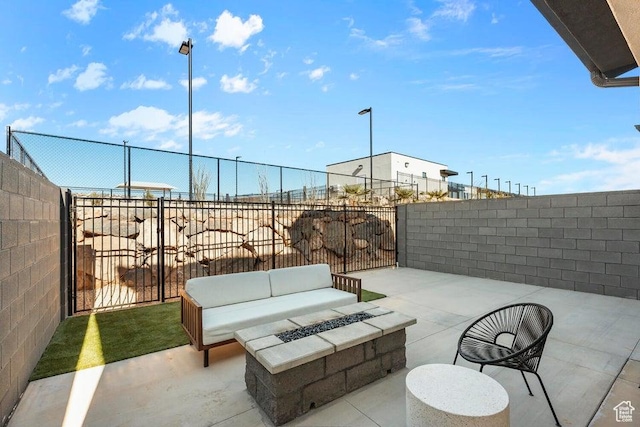view of patio featuring an outdoor living space with a fire pit and a fenced backyard