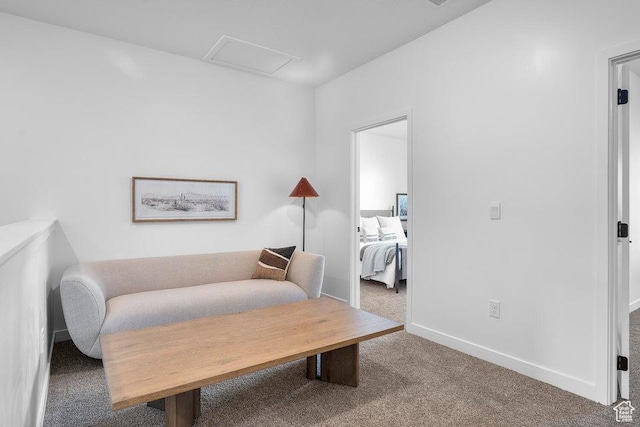 living area featuring carpet flooring and baseboards