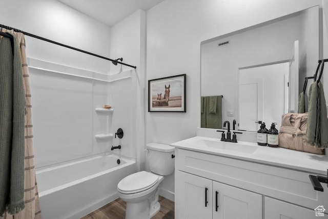 bathroom featuring vanity, wood finished floors, toilet, and shower / bathtub combination with curtain