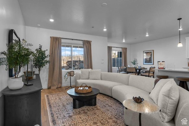living room with recessed lighting, wood finished floors, and baseboards