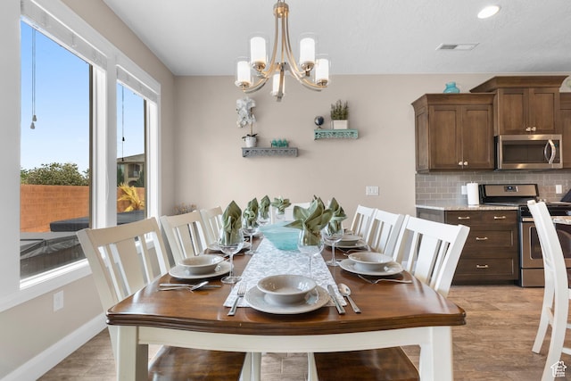 2691 S 3970 W, Hurricane, UT 84737 - dining room with visible vents, baseboards, light wood-style floors, and a chandelier