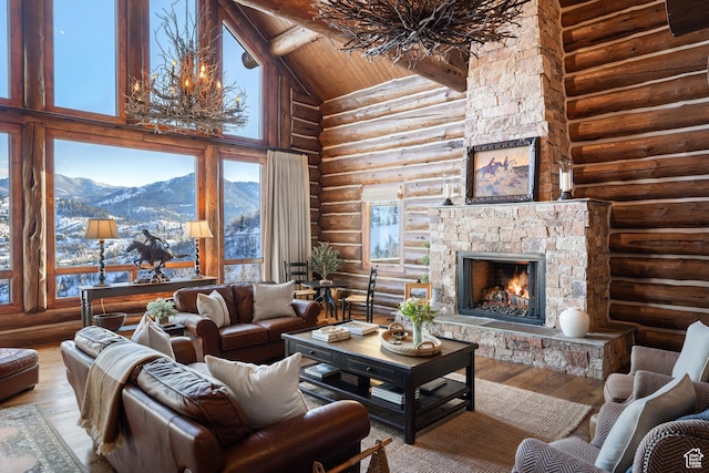 4115 Moose Hollow Loop, Park City, UT 84098 - living room featuring log walls, a mountain view, wood-type flooring, a fireplace, and wooden ceiling with exposed beams
