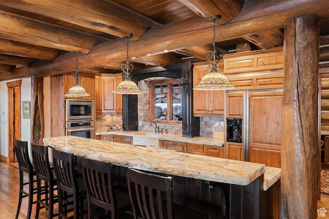 4115 Moose Hollow Loop, Park City, UT 84098 - kitchen featuring stainless steel appliances, a sink, tasteful backsplash, a kitchen breakfast bar, and wood finished floors