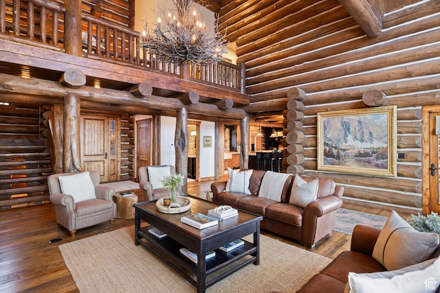 4115 Moose Hollow Loop, Park City, UT 84098 - living room featuring a chandelier, a towering ceiling, hardwood / wood-style floors, and rustic walls