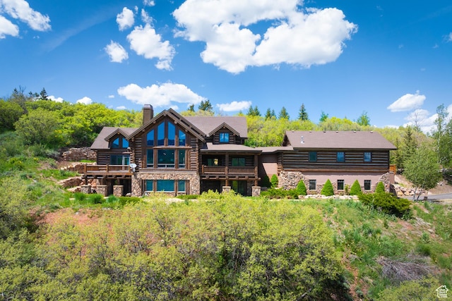 4115 Moose Hollow Loop, Park City, UT 84098 - rear view of house featuring a chimney, stone siding, a balcony, and log exterior
