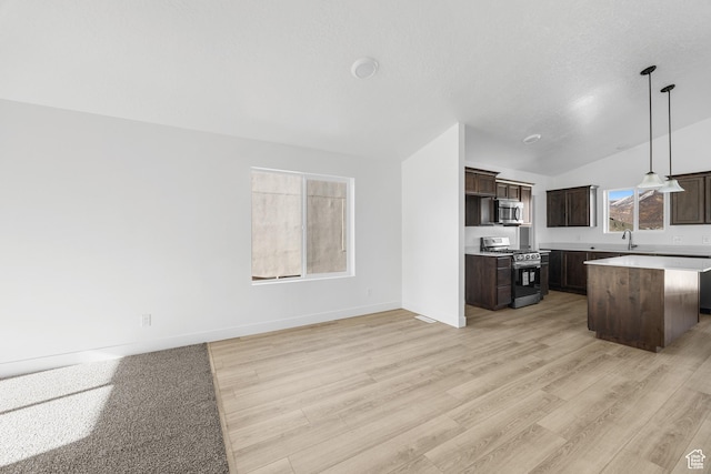 1667 S Marigold Way Unit 230E, Santaquin, UT 84655 - kitchen with a center island, light wood finished floors, dark brown cabinetry, and stainless steel appliances