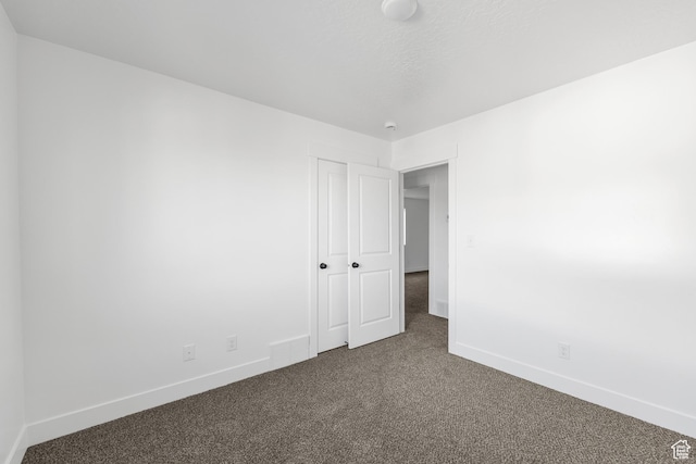 1667 S Marigold Way Unit 230E, Santaquin, UT 84655 - spare room featuring baseboards and dark colored carpet