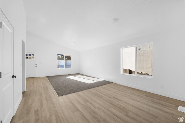 1667 S Marigold Way Unit 230E, Santaquin, UT 84655 - unfurnished living room with baseboards, high vaulted ceiling, and light wood-style floors