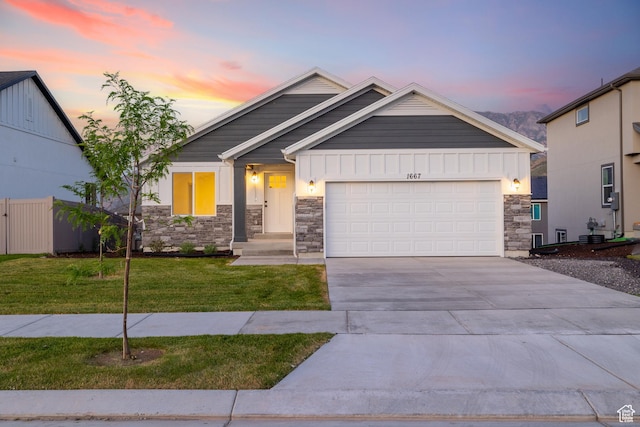 1667 S Marigold Way Unit 230E, Santaquin, UT 84655 - craftsman house with stone siding, a garage, a front lawn, board and batten siding, and concrete driveway