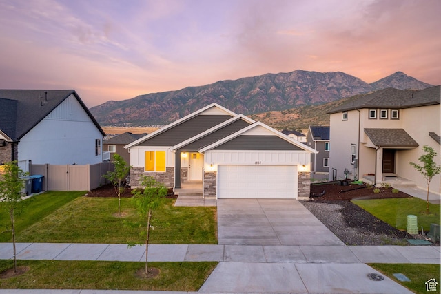 1667 S Marigold Way Unit 230E, Santaquin, UT 84655 - view of front of home featuring stone siding, a mountain view, and driveway