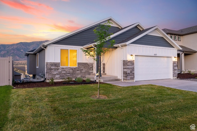 1667 S Marigold Way Unit 230E, Santaquin, UT 84655 - view of front of house featuring stone siding, board and batten siding, an attached garage, driveway, and a lawn