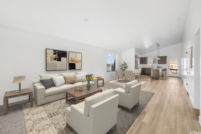 1667 S Marigold Way Unit 230E, Santaquin, UT 84655 - living area featuring healthy amount of natural light, light wood-style flooring, and lofted ceiling