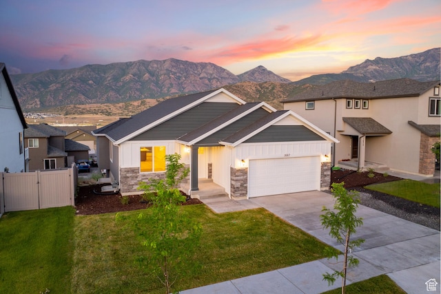 1667 S Marigold Way Unit 230E, Santaquin, UT 84655 - view of front facade featuring stone siding, driveway, an attached garage, board and batten siding, and a mountain view