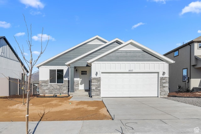 view of front of home featuring stone siding, board and batten siding, concrete driveway, and an attached garage
