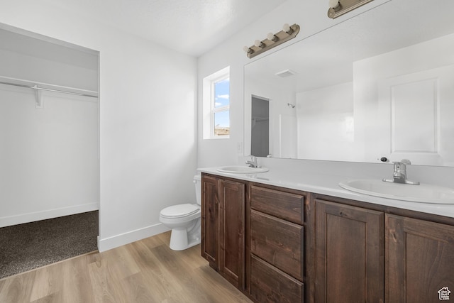 1667 S Marigold Way Unit 230E, Santaquin, UT 84655 - full bathroom featuring double vanity, a sink, toilet, and wood finished floors