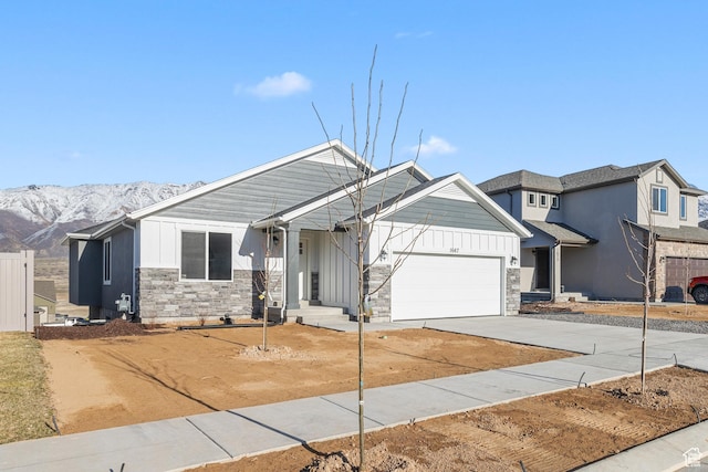 1667 S Marigold Way Unit 230E, Santaquin, UT 84655 - view of front of house with stone siding, board and batten siding, driveway, and a garage