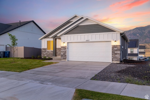 1667 S Marigold Way Unit 230E, Santaquin, UT 84655 - single story home with stone siding, driveway, an attached garage, a mountain view, and board and batten siding