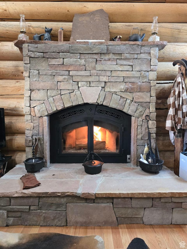 365 W Sleeping Rainbow Dr, Torrey, UT 84775 - room details featuring rustic walls, an outdoor stone fireplace, and wood finished floors