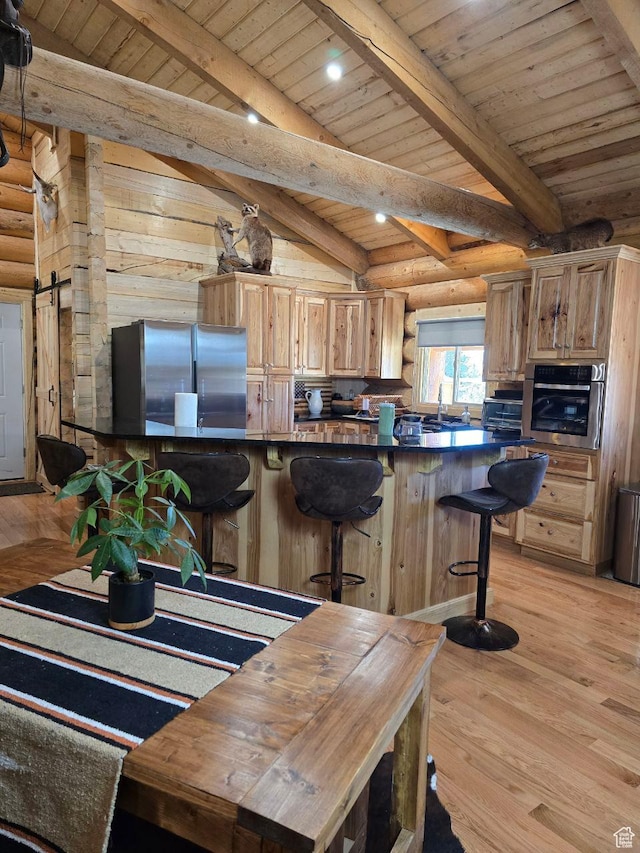 365 W Sleeping Rainbow Dr, Torrey, UT 84775 - kitchen featuring wooden ceiling, appliances with stainless steel finishes, light wood-style floors, and rustic walls