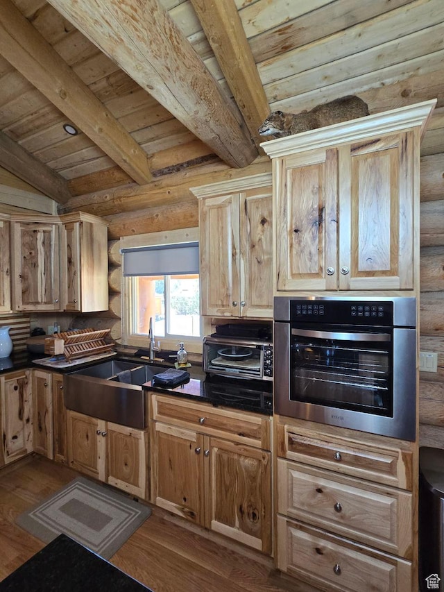 365 W Sleeping Rainbow Dr, Torrey, UT 84775 - kitchen with beamed ceiling, oven, wood finished floors, rustic walls, and a sink