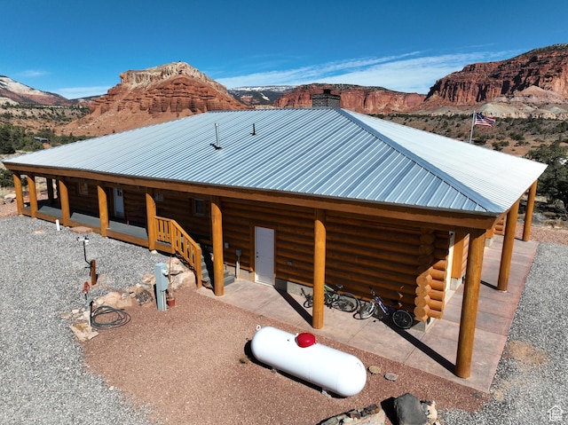 365 W Sleeping Rainbow Dr, Torrey, UT 84775 - view of side of property with log siding, metal roof, and a mountain view