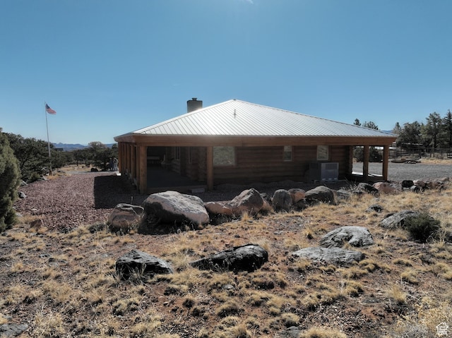 365 W Sleeping Rainbow Dr, Torrey, UT 84775 - view of home's exterior with metal roof, central air condition unit, and a chimney