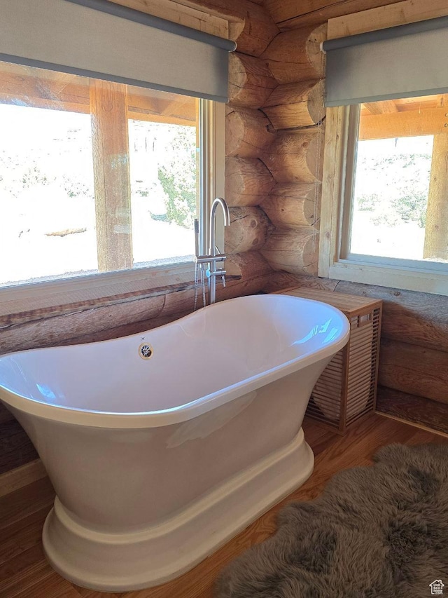 365 W Sleeping Rainbow Dr, Torrey, UT 84775 - full bathroom with a freestanding tub, wood finished floors, and log walls