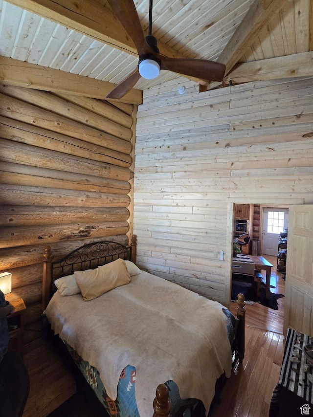 365 W Sleeping Rainbow Dr, Torrey, UT 84775 - bedroom featuring hardwood / wood-style floors, beamed ceiling, wooden ceiling, and log walls