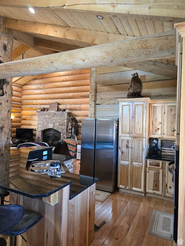 365 W Sleeping Rainbow Dr, Torrey, UT 84775 - kitchen featuring light wood finished floors, rustic walls, wood ceiling, and freestanding refrigerator