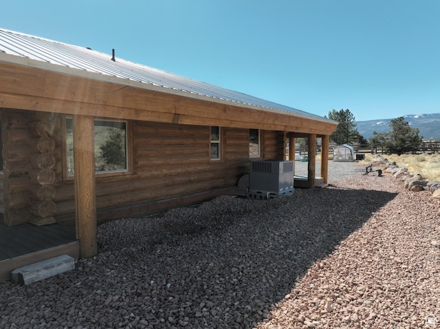 365 W Sleeping Rainbow Dr, Torrey, UT 84775 - back of house with metal roof, a mountain view, central AC, and log exterior