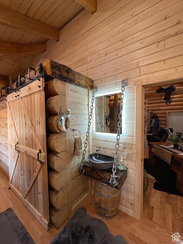 365 W Sleeping Rainbow Dr, Torrey, UT 84775 - bathroom with wooden ceiling, a sink, vaulted ceiling with beams, wood finished floors, and wood walls