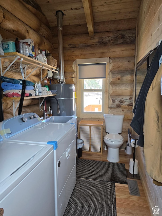 365 W Sleeping Rainbow Dr, Torrey, UT 84775 - clothes washing area with light wood-type flooring, separate washer and dryer, wood ceiling, visible vents, and laundry area