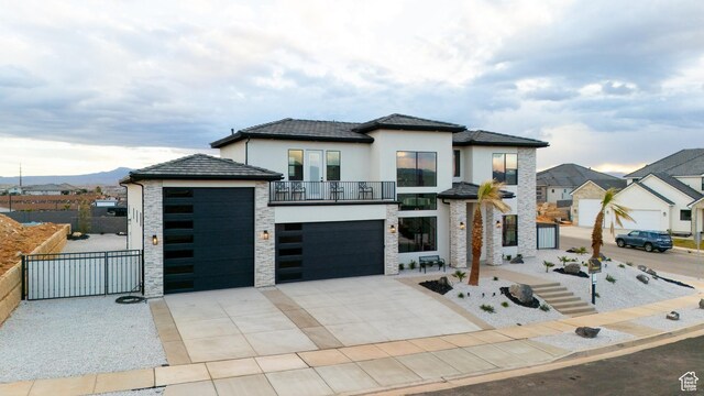1036 E Fremont St, Washington, UT 84780 - view of front of home featuring fence, concrete driveway, stucco siding, a garage, and stone siding