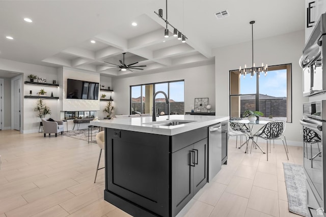 1036 E Fremont St, Washington, UT 84780 - kitchen with visible vents, a sink, ceiling fan with notable chandelier, stainless steel appliances, and dark cabinets
