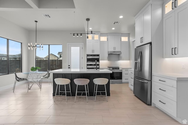 1036 E Fremont St, Washington, UT 84780 - kitchen with visible vents, a breakfast bar area, stainless steel appliances, and light countertops