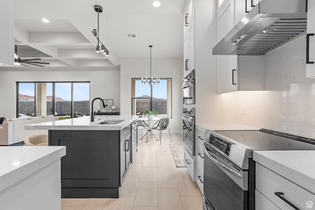 1036 E Fremont St, Washington, UT 84780 - kitchen featuring a sink, stainless steel appliances, light countertops, white cabinets, and wall chimney exhaust hood