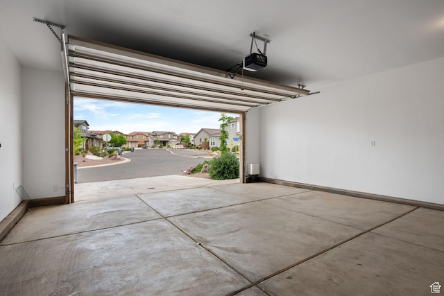 262 Ladera Dr, Washington, UT 84780 - garage with baseboards, a residential view, and a garage door opener