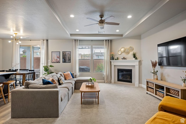 262 Ladera Dr, Washington, UT 84780 - carpeted living area with a wealth of natural light, baseboards, a glass covered fireplace, and ceiling fan with notable chandelier