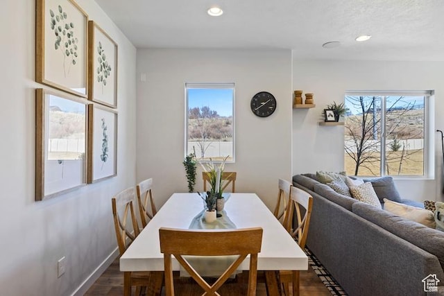 dining space with a wealth of natural light, recessed lighting, and dark wood-style flooring
