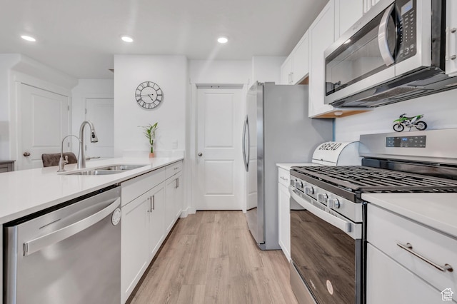 388 N Regatta Ln, Saratoga Springs, UT 84045 - kitchen with appliances with stainless steel finishes, white cabinetry, light countertops, and a sink