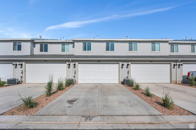 388 N Regatta Ln, Saratoga Springs, UT 84045 - multi unit property with central AC unit, stucco siding, an attached garage, and driveway