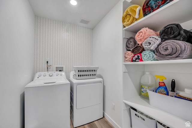 388 N Regatta Ln, Saratoga Springs, UT 84045 - laundry room featuring light wood finished floors, visible vents, an accent wall, laundry area, and washer and dryer